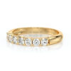 Bague en or jaune avec diamants brillants, mettant en avant une rangée de diamants ronds disposés avec élégance. Ce bijou vintage évoque luxe et raffinement, parfait pour les occasions spéciales ou comme bague de fiançailles. Son design classique en fait un choix intemporel pour les amateurs de joaillerie.