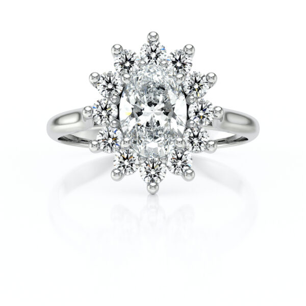 Bague en or blanc ornée d'un diamant central en forme ovale, entouré de petites pierres brillantes disposées en couronne, offrant un éclat exceptionnel, idéale pour les fiançailles ou les occasions spéciales. Modèle + diamant.