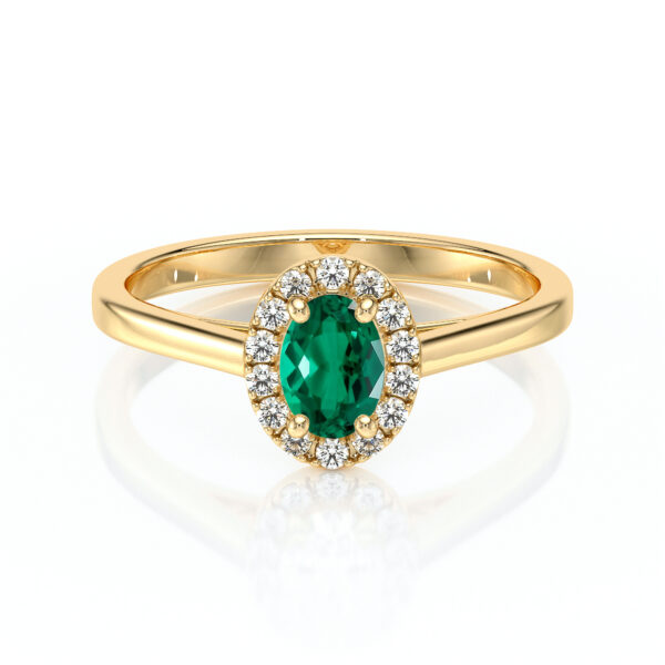 Bague en or avec une pierre précieuse verte ovale au centre entourée de diamant, modèle élégant et raffiné, idéale pour les fiançailles ou les occasions spéciales. Design contemporain avec une touche classique, parfait pour les amoureux de bijoux uniques.