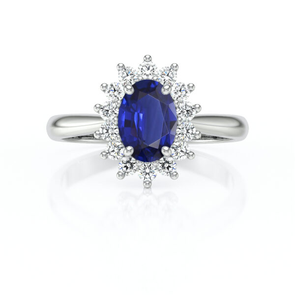 Bague en or blanc ornée d'un saphir ovale bleu vif, entouré de diamants scintillants, parfaite pour une proposition ou comme bijou de luxe. Modèle romantique avec un design élégant qui met en valeur la brillance des gemmes.