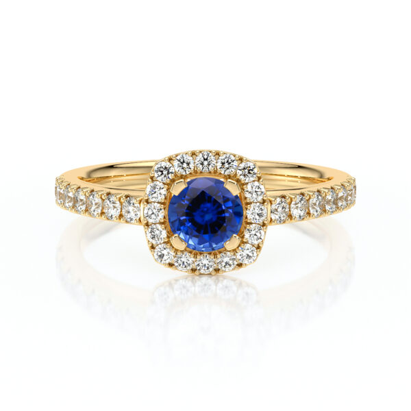 Bague en or avec un diamant central bleu, entourée de diamants scintillants sur un anneau délicat. Idéale pour les fiançailles ou comme bijou de luxe, cette bague allie élégance et sophistication, mettant en valeur la pierre précieuse au centre et le travail artisanal de haute qualité.