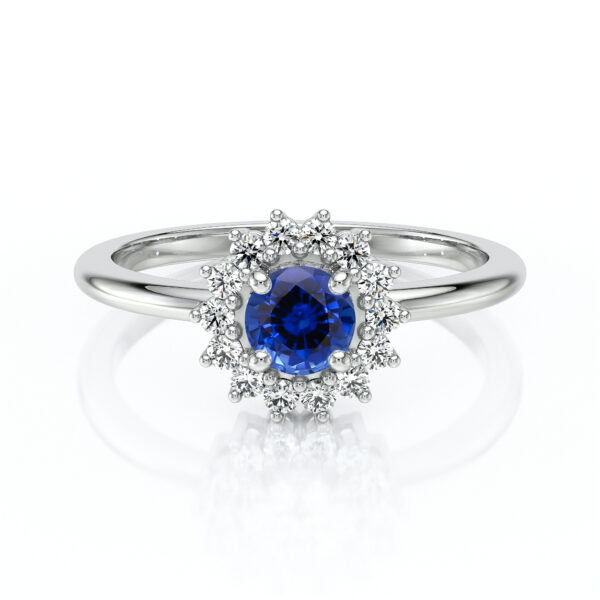Bague de fiançailles en or blanc ornée d'un saphir bleu en forme de fleur entouré de diamants brillants. Cette pièce unique incarne l'élégance et la sophistication, parfaite pour symboliser un amour éternel. Modèle contemporain avec design floral, idéale pour les demandes en mariage.