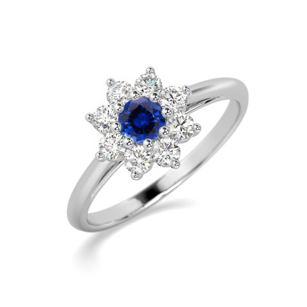 Bague en or blanc ornée d'une pierre précieuse en saphir bleu central entourée de diamants étincelants en forme de fleur, idéale pour une proposition de mariage ou un cadeau élégant, bijou de luxe mettant en valeur un design sophistiqué et intemporel.
